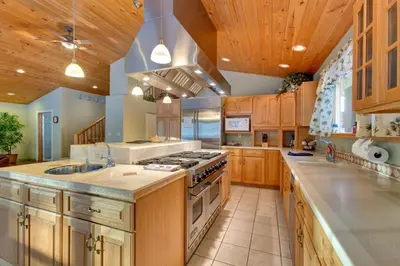 a large kitchen with wooden cabinets and a stove top oven at Sequoia Chalet home in Stateline