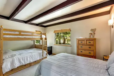 a bedroom with two bunk beds and a dresser at Cold Creek Lodge home in South Lake Tahoe