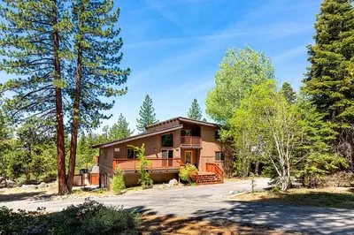 a house in the woods with a driveway at Cold Creek Lodge home in South Lake Tahoe