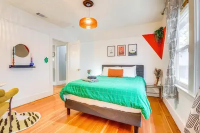 a bedroom with a bed with a green comforter at Midtown Oasis w BBQ Deck Games and Artistic Vibes in Sacramento
