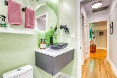 a bathroom with a sink and a mirror at Midtown Oasis w BBQ Deck Games and Artistic Vibes in Sacramento