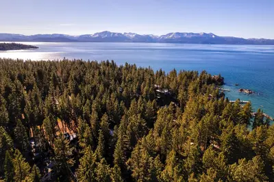 an aerial view of a forested island in a body of water at Silver Rock Lodge home in Zephyr Cove