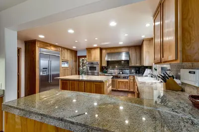 a kitchen with wooden cabinets and a granite counter top at Silver Rock Lodge home in Zephyr Cove