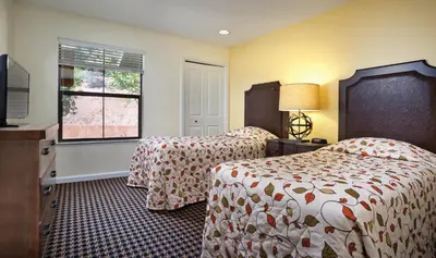 a hotel room with two beds and a window at Wyndham Angels Camp 2BR Apartment with Resort Access in Angels Camp