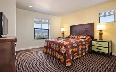 a bedroom with a bed and a flat screen tv at Wyndham Angels Camp 3BR Apartment with Resort Access in Angels Camp
