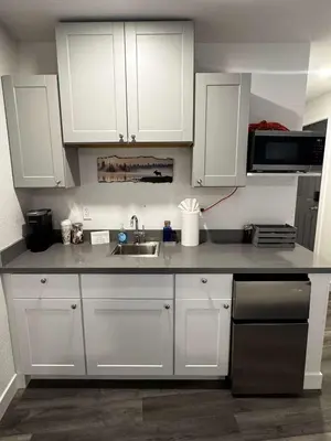 a kitchen with white cabinets and a sink at #9 Lakeside Location Beach Access View BalconyDog in Kings Beach