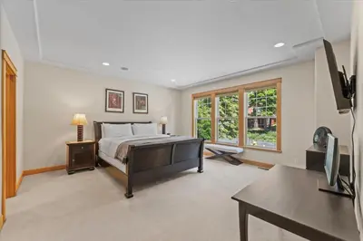 a bedroom with a bed and a desk and a tv at Wooded Escape in Tahoe Vista Private Hot Tub in Tahoe Vista
