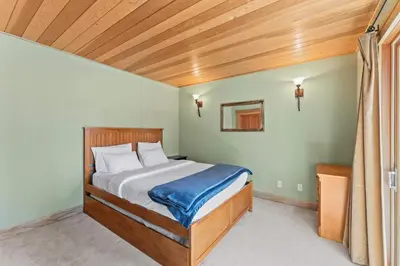 a bedroom with a bed with a wooden ceiling at Wooded Escape in Tahoe Vista Private Hot Tub in Tahoe Vista