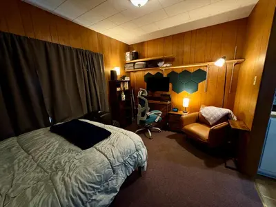 a bedroom with a bed and a chair and a desk at 1br 1ba private ADU in Sacramento