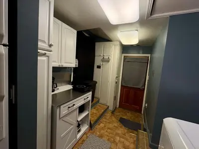 a small kitchen with white cabinets and a stove at 1br 1ba private ADU in Sacramento