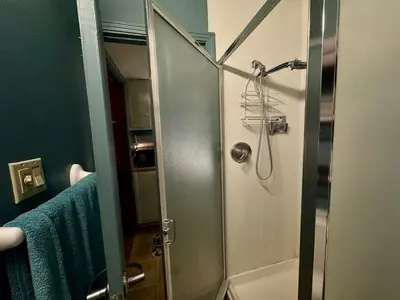 a shower with a glass door in a bathroom at 1br 1ba private ADU in Sacramento