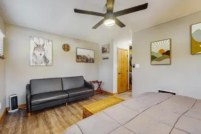 a bedroom with a bed and a couch at Little Cozy Cabin in Shaver Lake