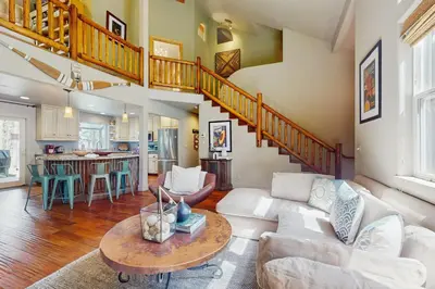 a living room with a white couch and a table at Serenity Summit in South Lake Tahoe