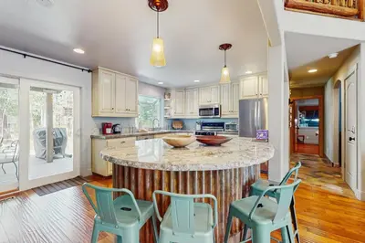 a kitchen with a center island with blue stools at Serenity Summit in South Lake Tahoe