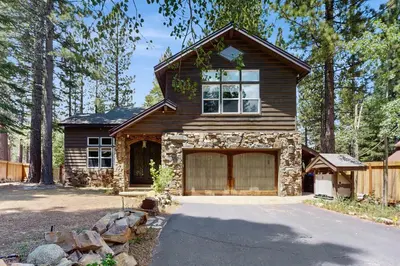 a house with a garage in front of a driveway at Serenity Summit in South Lake Tahoe
