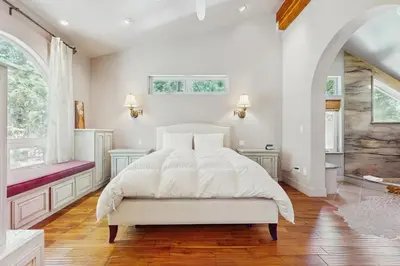 a white bedroom with a bed and a window at Serenity Summit in South Lake Tahoe