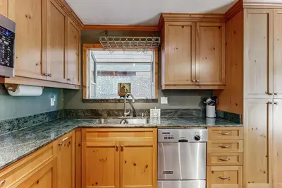 a kitchen with wooden cabinets and a sink at The Rikz Cabin in South Lake Tahoe