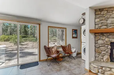 a living room with a table and chairs and a fireplace at The Rikz Cabin in South Lake Tahoe