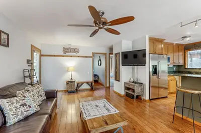 a living room with a couch and a ceiling fan at The Rikz Cabin in South Lake Tahoe