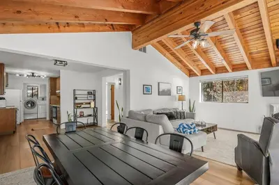 a living room with a table and a couch at Tahoe Peaks & Shores Getaway in Kings Beach