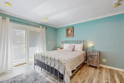 a bedroom with a bed with blue walls and a window at Mountain Serenity in Incline Village