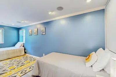 a blue room with a bed and a couch at Mountain Serenity in Incline Village
