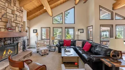 a living room with a leather couch and a fireplace at Crystal View by AvantStay Al Fresco Dining w View of Lake Tahoe Crystal Bay in Incline Village