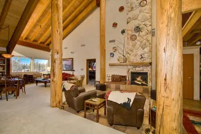 a large living room with a stone fireplace at Downtown Penthouse condo in South Lake Tahoe