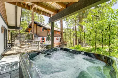 a hot tub on the patio of a house at Walk to Diamond Peak Luxe Chalet with Mtn-View Deck in Incline Village