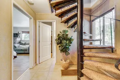 a hallway with a spiral staircase in a home at Walk to Diamond Peak Luxe Chalet with Mtn-View Deck in Incline Village