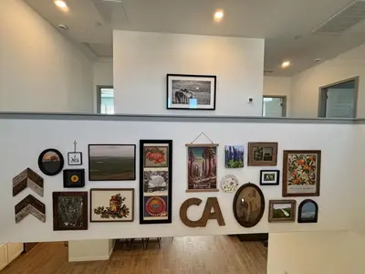 a wall with a bunch of pictures on it at Joyhouse in Visalia