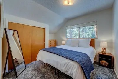 a bedroom with a large bed and a window at Peak Summer - Relax & Refresh - Charming Kings Beach in Tahoe Vista