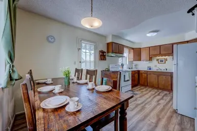 a kitchen with a wooden table with plates on it at Peak Summer - Relax & Refresh - Charming Kings Beach in Tahoe Vista