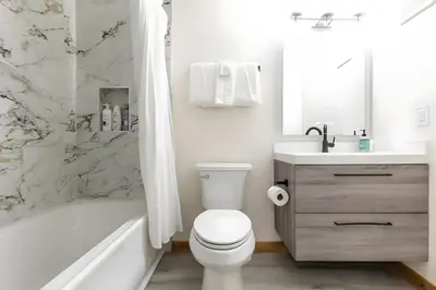 a white bathroom with a toilet and a sink at 1BDR Condo in the Heart of Olympic Valley! in Tahoe City