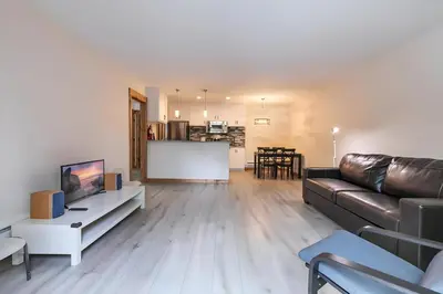 a living room with a leather couch and a table at 1BDR Condo in the Heart of Olympic Valley! in Tahoe City