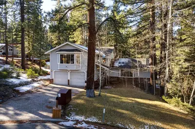 a house in the woods with a garage at Panhandle House home in South Lake Tahoe