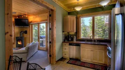 a kitchen with a stove and a couch in a cabin at Rock Haven condo in Stateline
