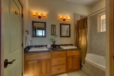 a bathroom with two sinks and a tub at Rock Haven condo in Stateline