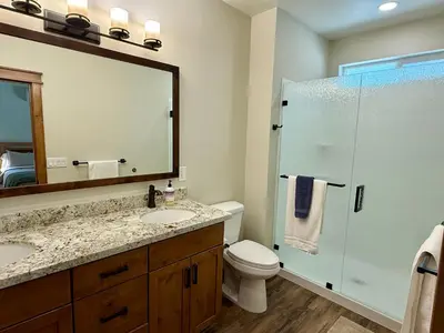 a bathroom with a toilet and a sink and a mirror at Black Bear Bungalow in White Wolf