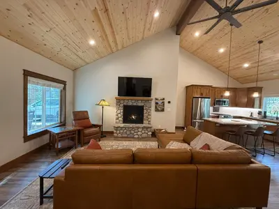 a living room with a couch and a fireplace at Black Bear Bungalow in White Wolf