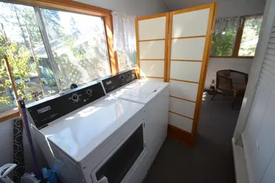 a kitchen with a stove and a window at Lakeside Cabin with lake view in Bass Lake