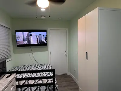 a room with a flat screen tv on the wall at Macau Studio-Guesthouse by Sac State and UCDMC in Sacramento