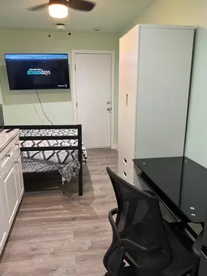 a room with a desk and a chair and a television at Macau Studio-Guesthouse by Sac State and UCDMC in Sacramento