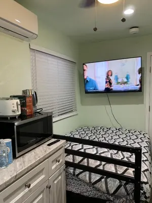 a room with a bed and a flat screen tv at Macau Studio-Guesthouse by Sac State and UCDMC in Sacramento