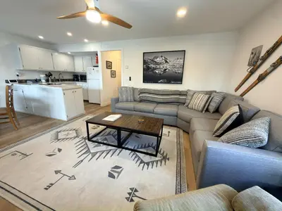 a living room with a couch and a table at Fireside Condo at the Village - Remodeled in Mammoth Lakes