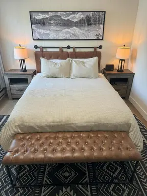 a bedroom with a large bed with two end tables at Fireside Condo at the Village - Remodeled in Mammoth Lakes