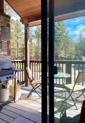 a screened in porch with a table and a grill at Fireside Condo at the Village - Remodeled in Mammoth Lakes