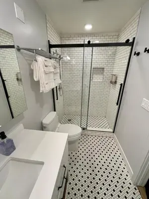 a bathroom with a shower and a toilet and a sink at Fireside Condo at the Village - Remodeled in Mammoth Lakes