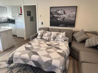 a bedroom with a bed and a couch at Fireside Condo at the Village - Remodeled in Mammoth Lakes