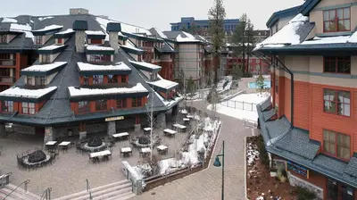 a large building with a courtyard with tables and chairs at Marriott Timber Lodge 1BR Apartment with Resort Access in South Lake Tahoe